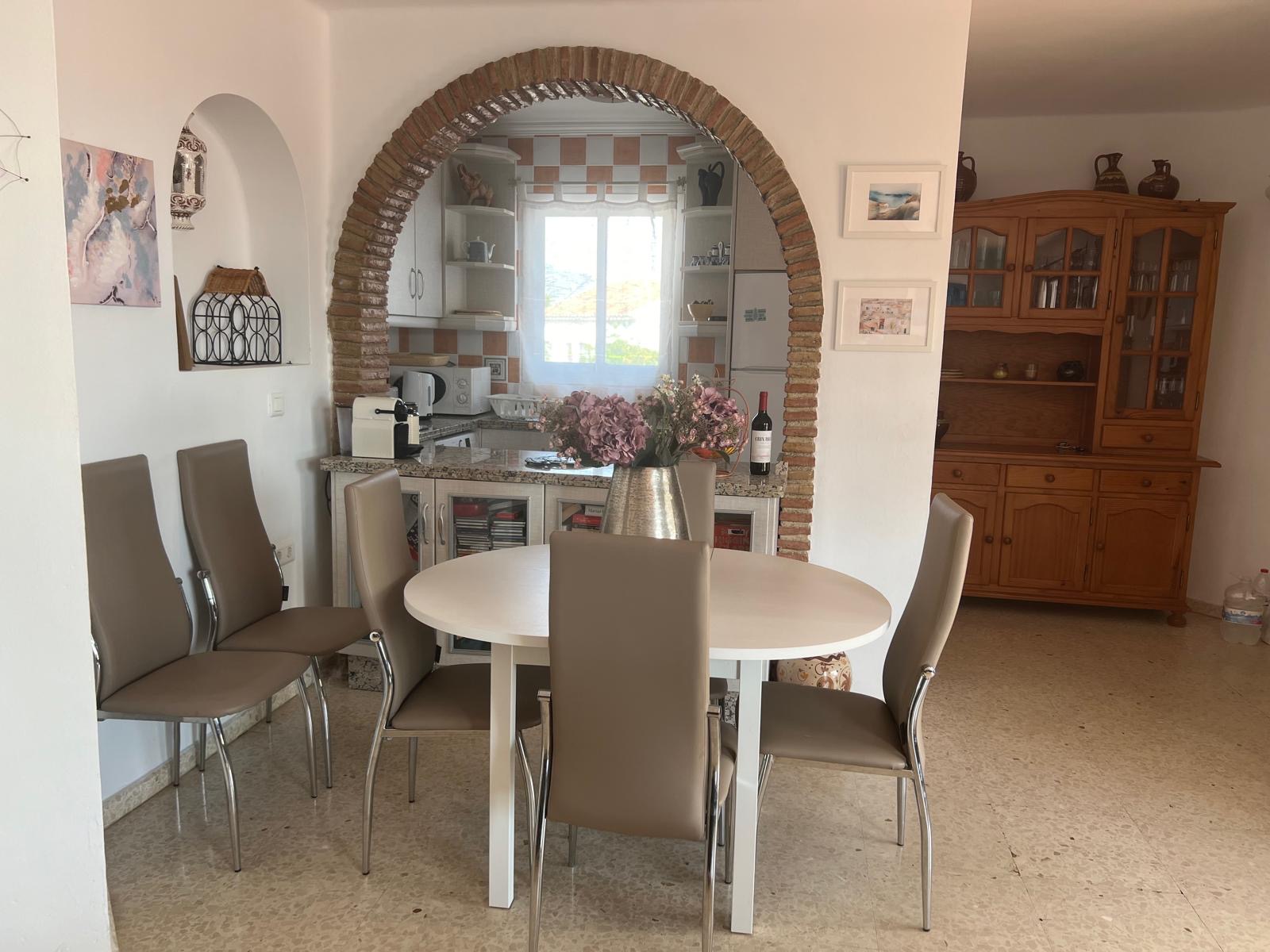 Dining area and kitchen through the arch
