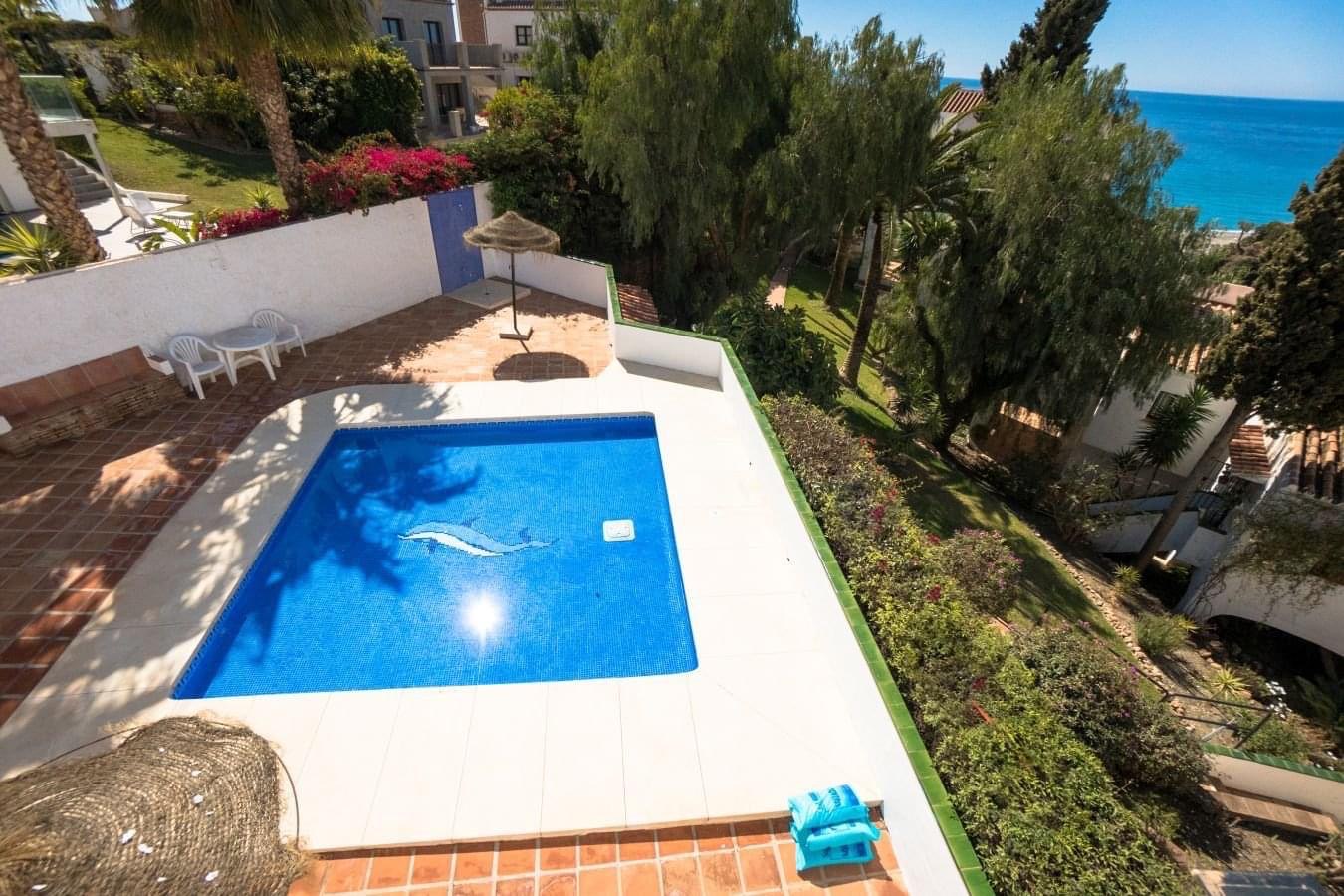 Aerial view of the communal pool with the Mediterranean beyond