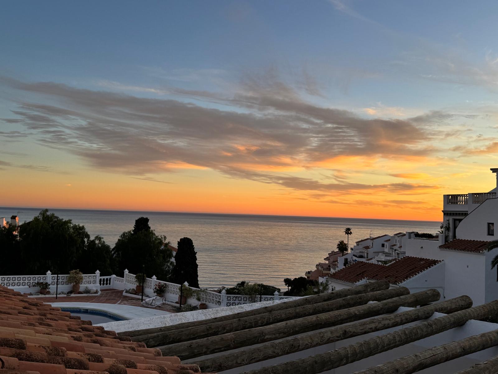 Sunset over the sea from the terrace pergola