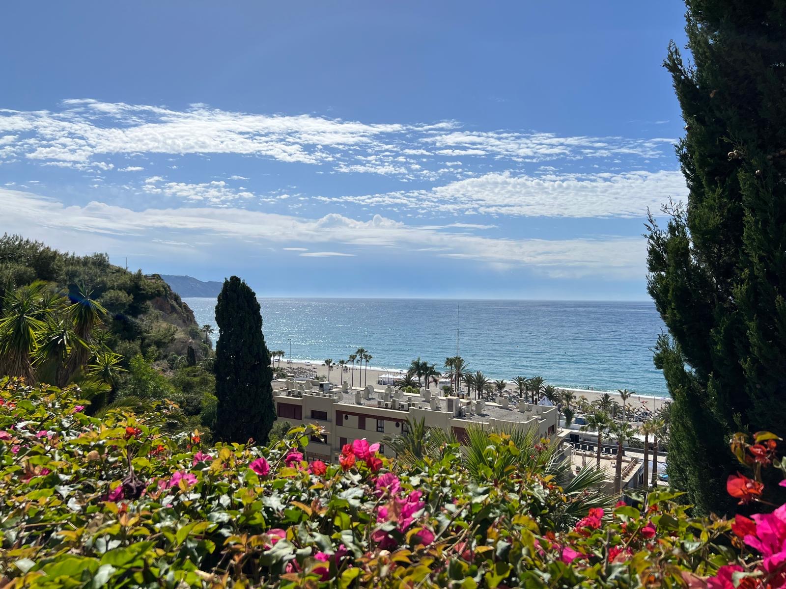 Burriana Beach seen through bougainvillea from the walk down