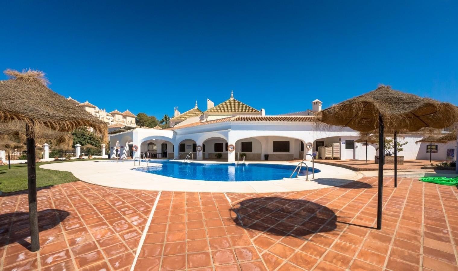 Communal swimming pool and sun terrace at Capistrano Playa
